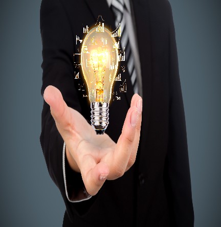 Business man holding light bulb